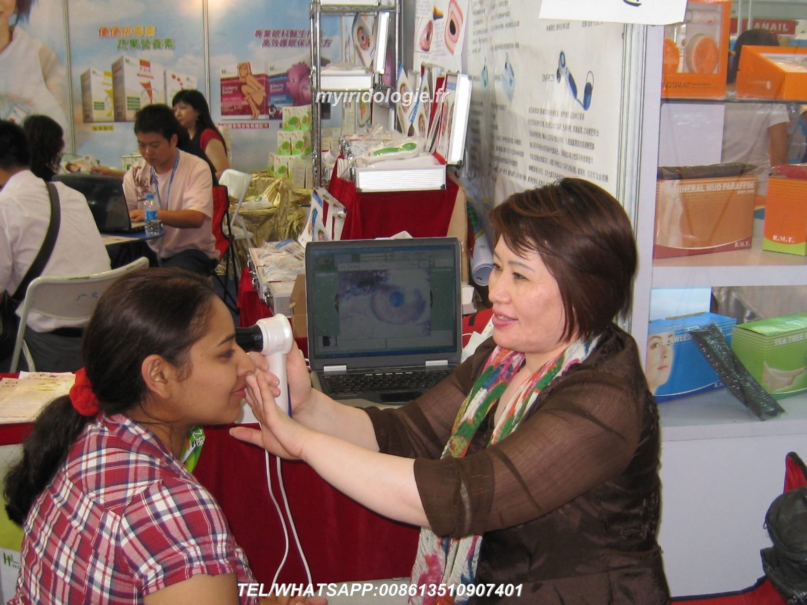 A professional iridology camera on a timber consultation desk next to a display monitor in South Africa
